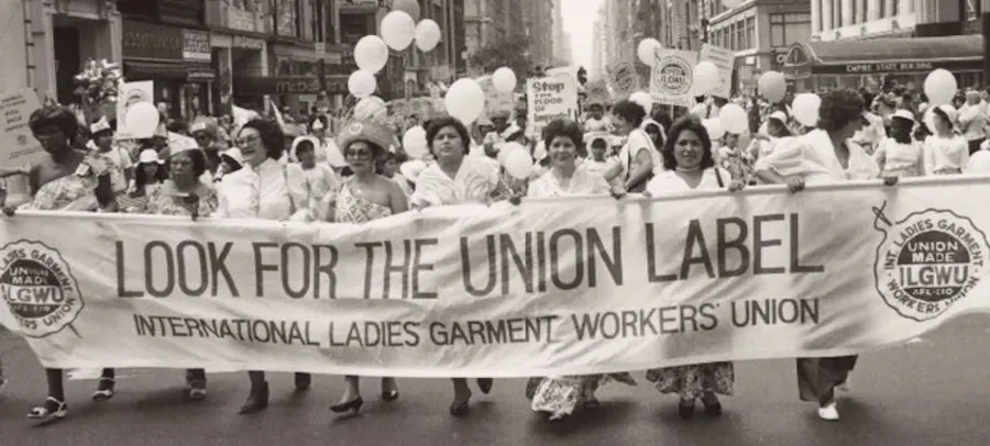 A picture of union workers with a sign reading "Look for the union label."